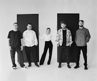 a black and white photo of a group of people posing for a photo